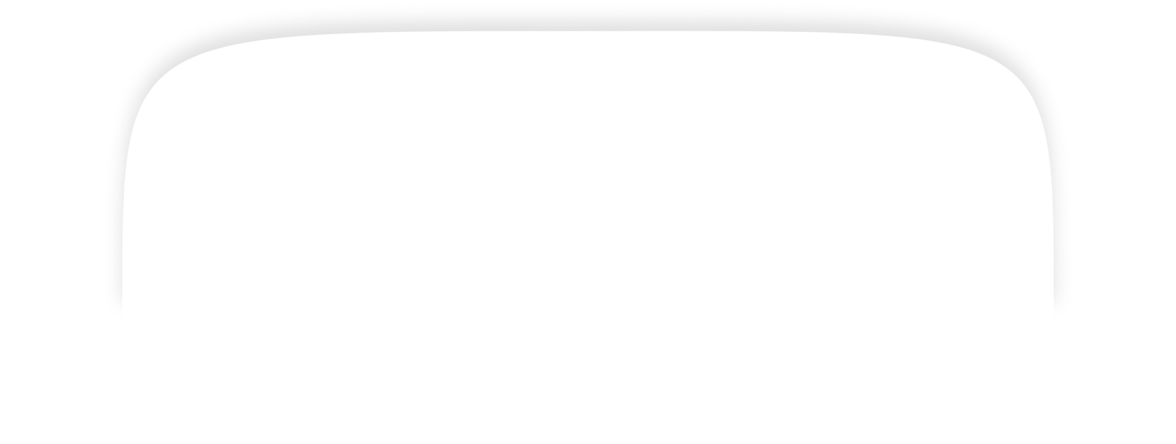 Person driving a car on a road surrounded by lush greenery, mountains in the distance, visible through a rearview mirror. No recognizable landmarks.