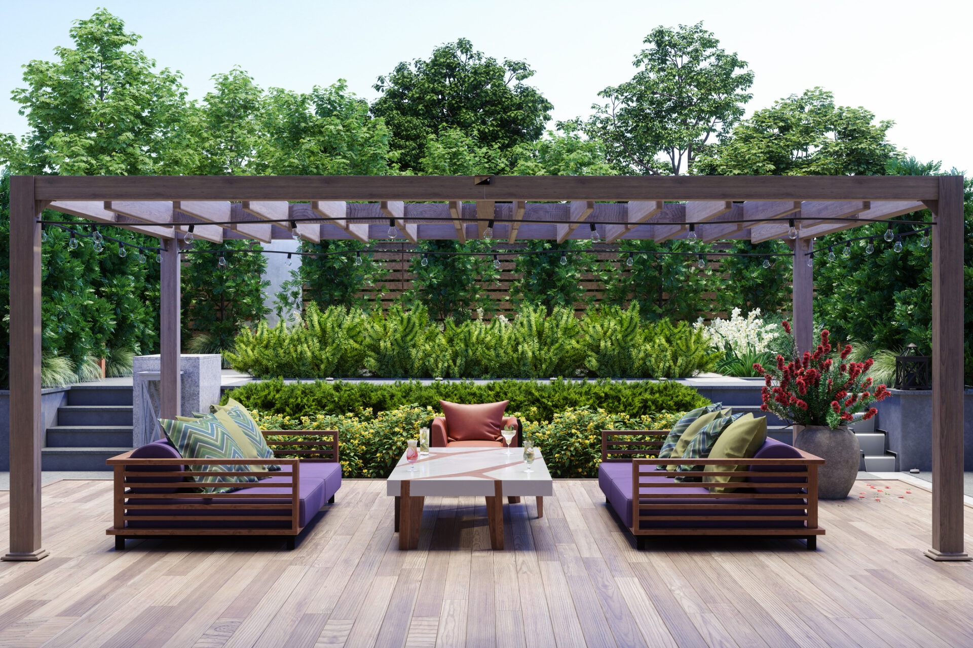 Outdoor patio with a wooden pergola, lush greenery, modern furniture, and decorative cushions, creating a serene garden ambiance.