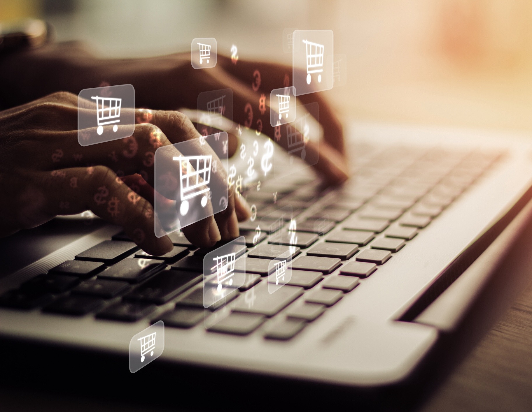 A person typing on a keyboard, with digital shopping cart icons overlayed, represents online shopping and e-commerce in a modern, digital environment.