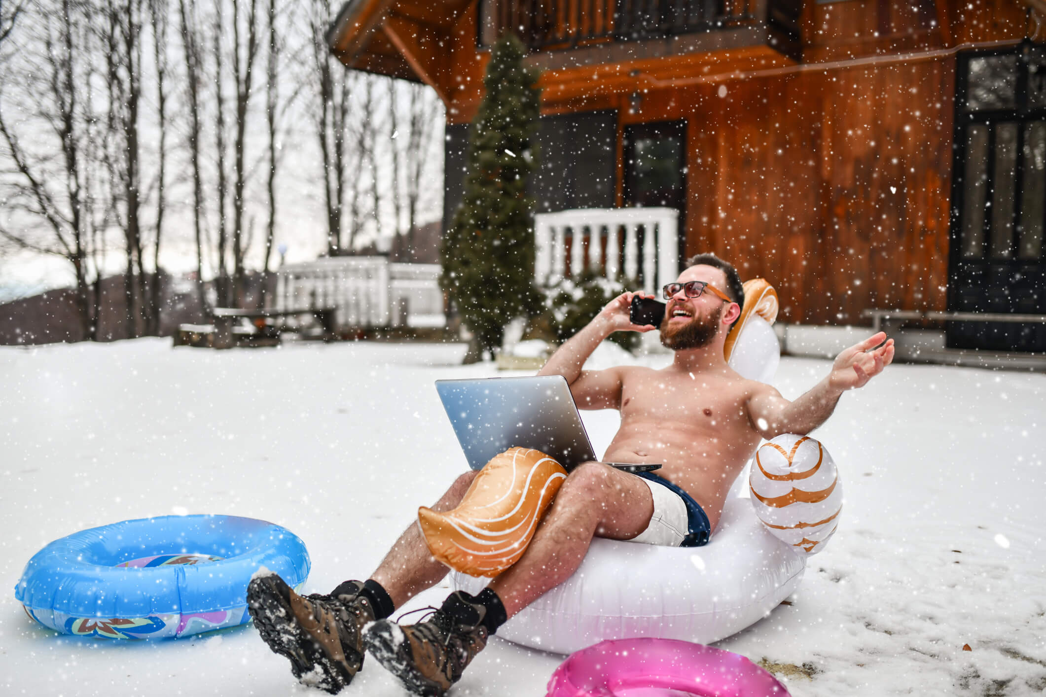 Man sitting in a pool floaty during the winter